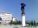 Памятник Пионерам освоения Уренгоя на фоне здания Уренгойгазпрома и нового ж/д вокзала
